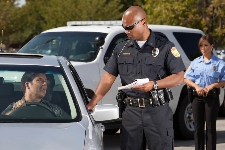 driver getting traffic ticket from cop