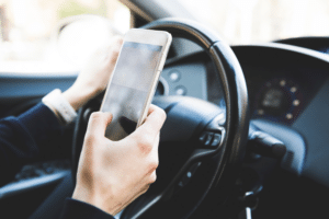 using phone while driving car street legal