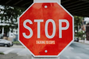 Approaching a stop sign at an Ontario intersection with a sticker added to it saying 'don't talk to cops'